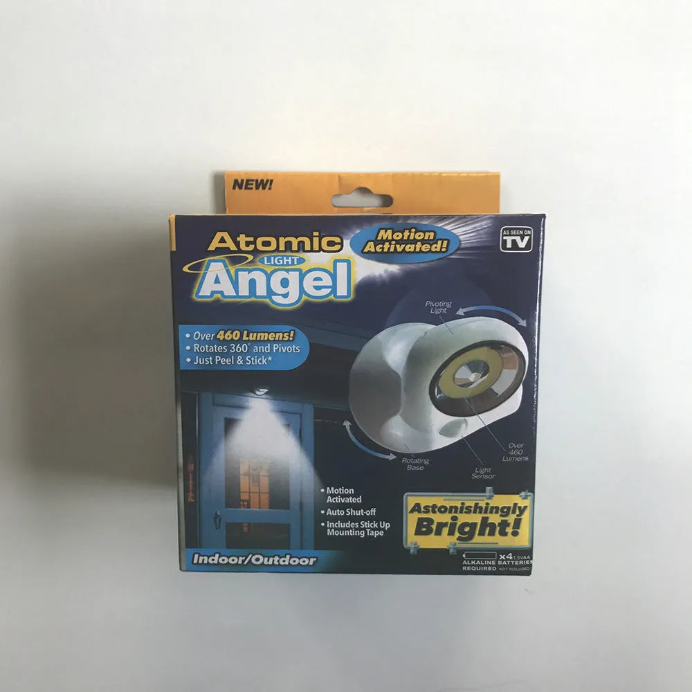 White Atomic Angel induction lamp with compact ABS housing on charging base.