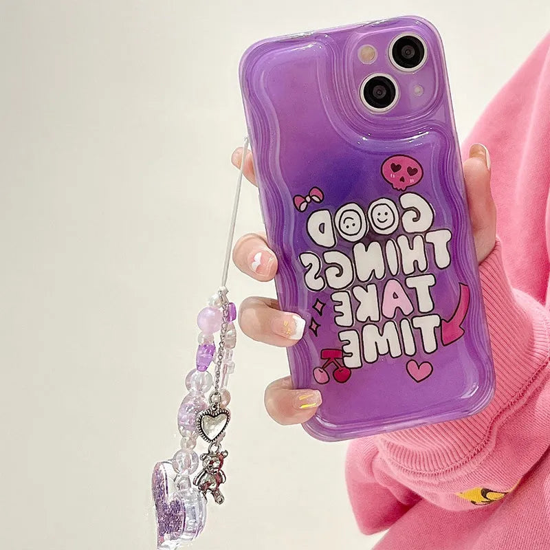 Purple graffiti love design iPhone 14 phone case with an attached silver chain bracelet.