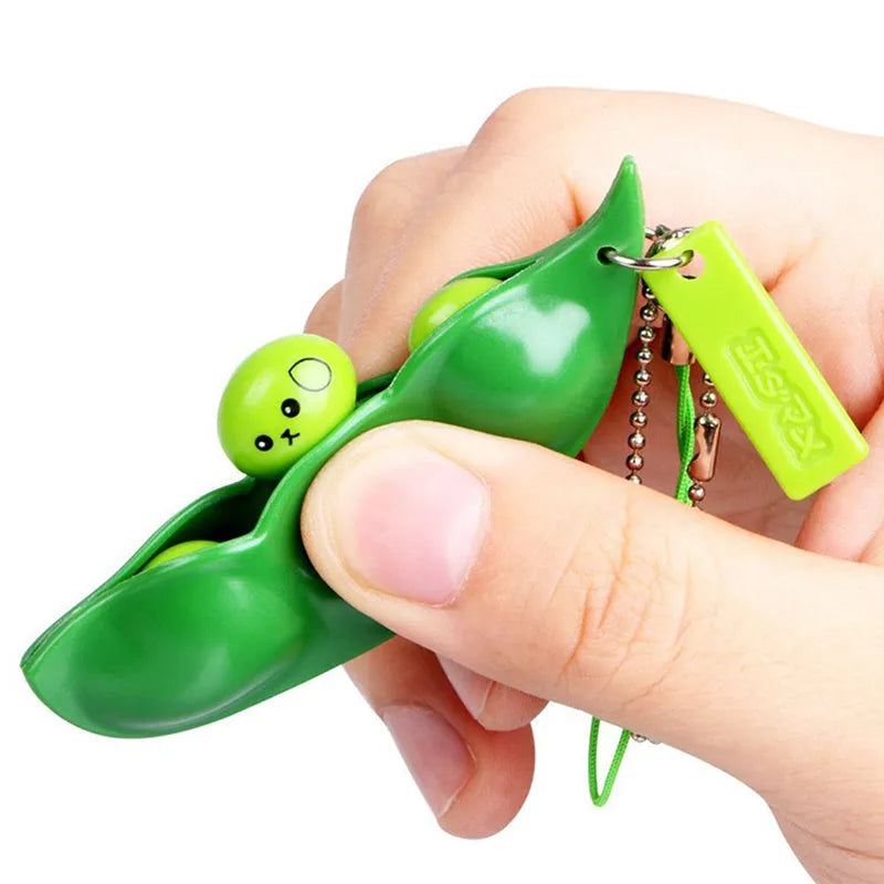 Green PU squeeze toy shaped like a bean pod, used as a pendant for stress relief