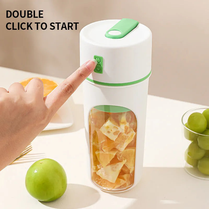 Blue portable electric juicer with USB charging cable next to a cup of blended fruit smoothie.