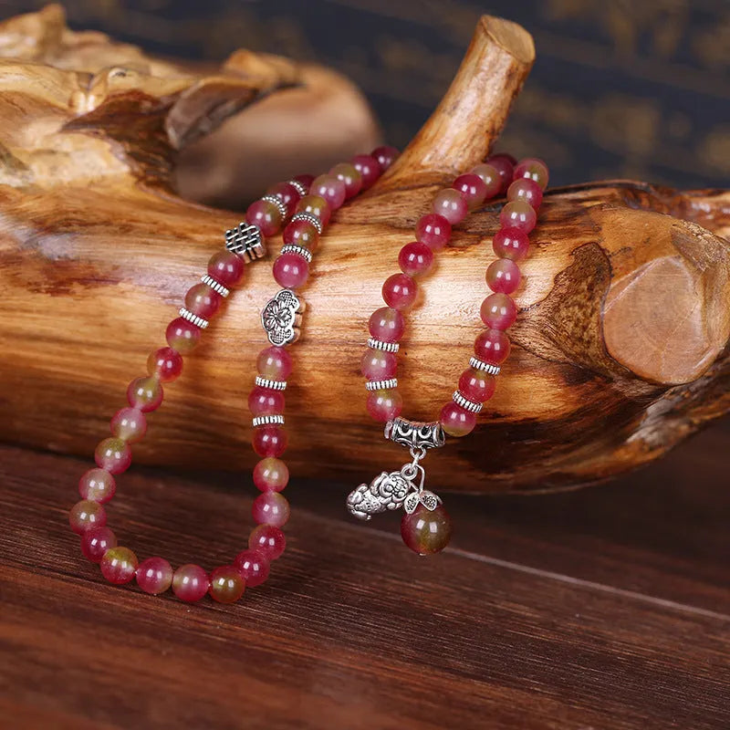Handcrafted watermelon crystal bracelet with Chinese knot design showing 8mm elephant-style beads