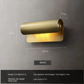 Simple modern copper wall lamp with warm light, 26cm long, on a living room wall