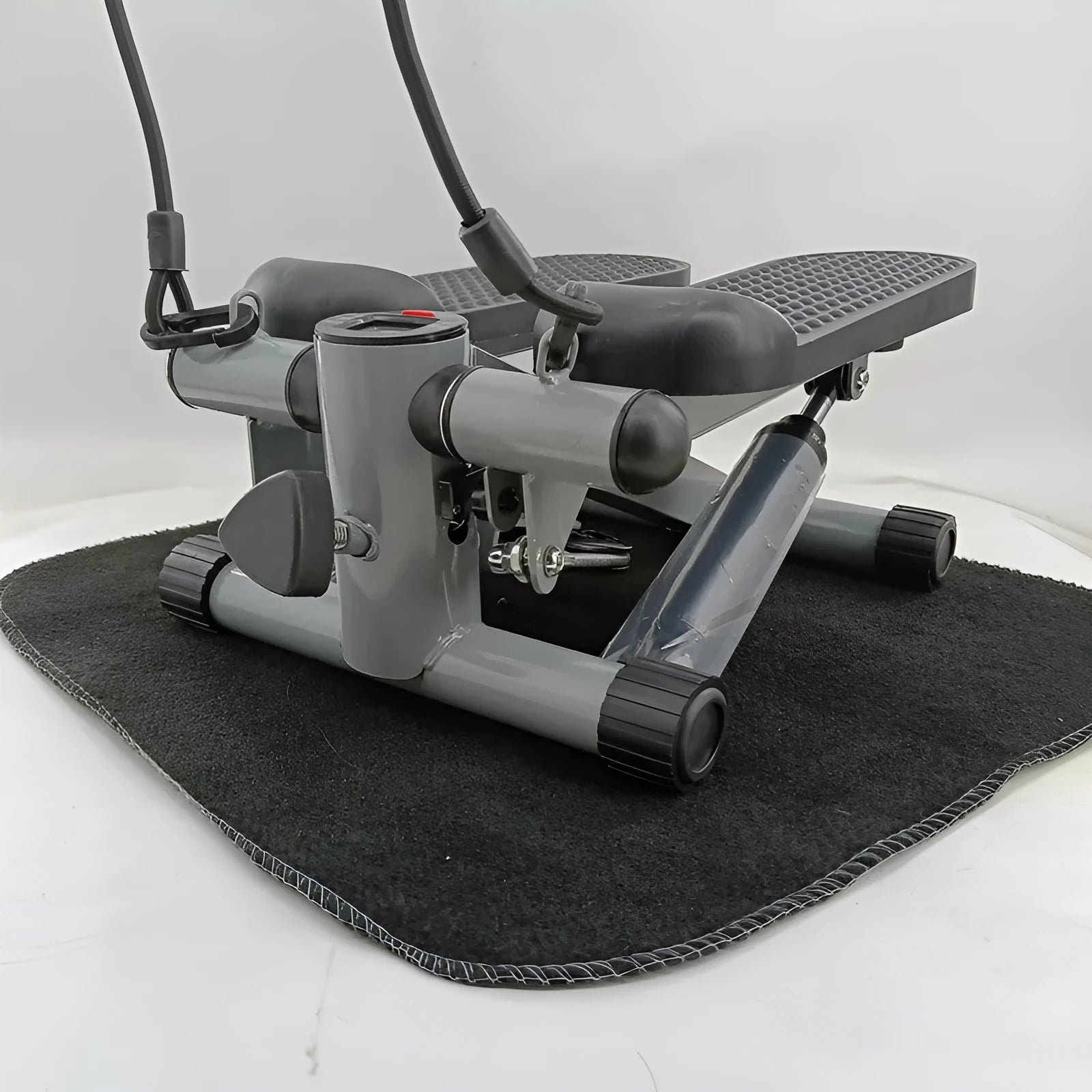 Silver grey hydraulic mini treadmill waist slimming pedal exercise machine for home use.