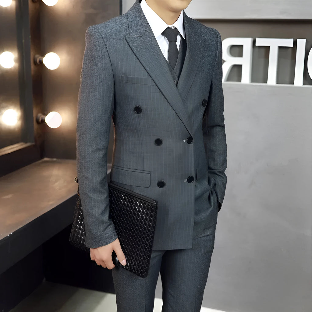 Men's black three-piece suit set with jacket, vest, and trousers, slim fit, anti-wrinkle fabric, on a mannequin.