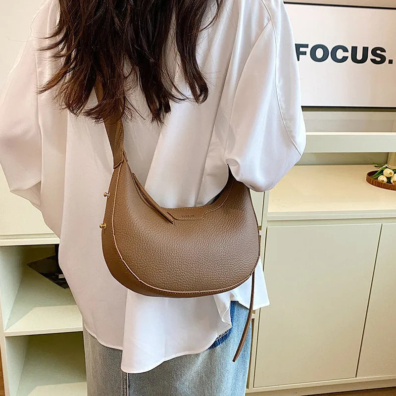 Women's one shoulder crossbody underarm handbag in PU, dumpling shape, 23cm wide, 120cm strap, black