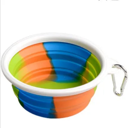 Collapsible silicone dog bowl in camouflage pattern folded flat on green surface