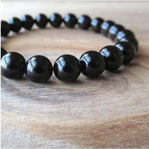 Women's geometric black agate bracelet with elastic cord, shown in 8mm bead size.