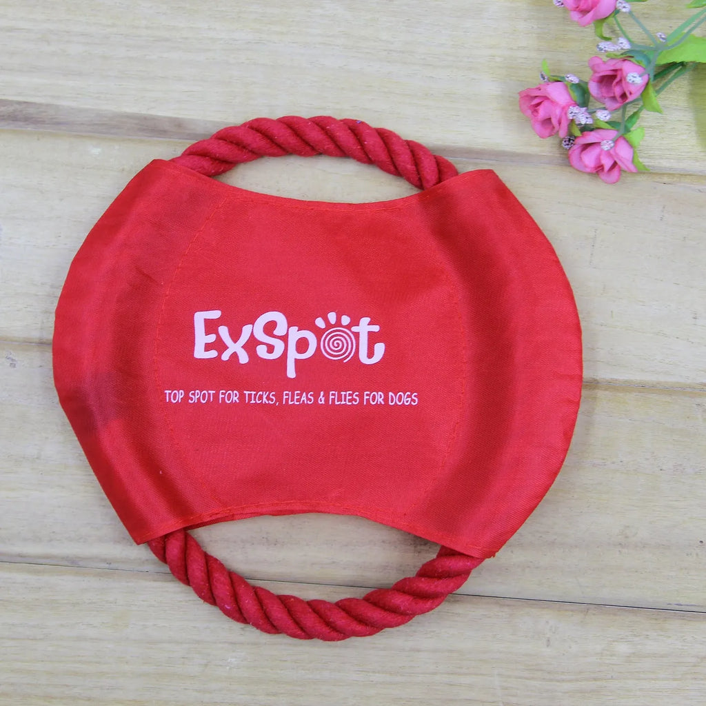 Canvas and rope dog flying disc toy with rain silk surface, 19cm diameter, on grass