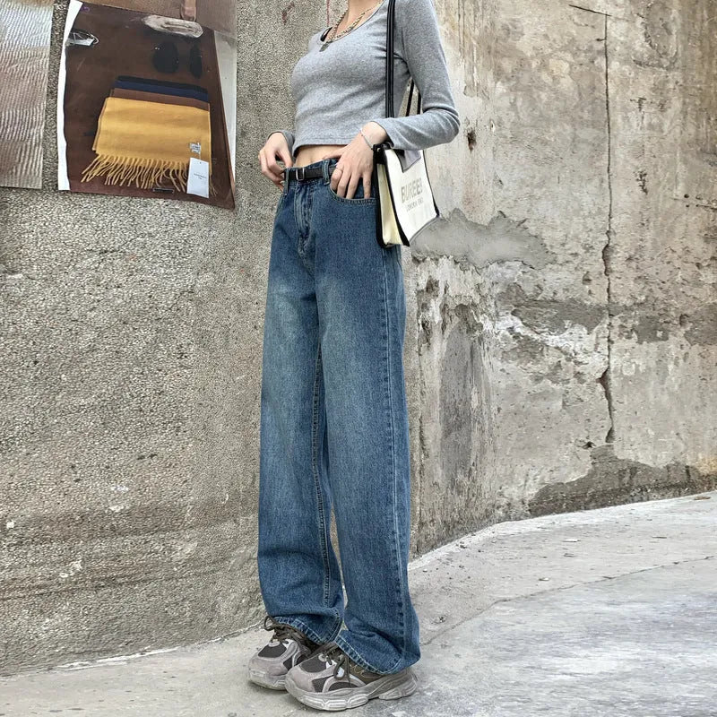 Woman wearing retro blue high-waisted straight-leg jeans in a cotton denim fabric.