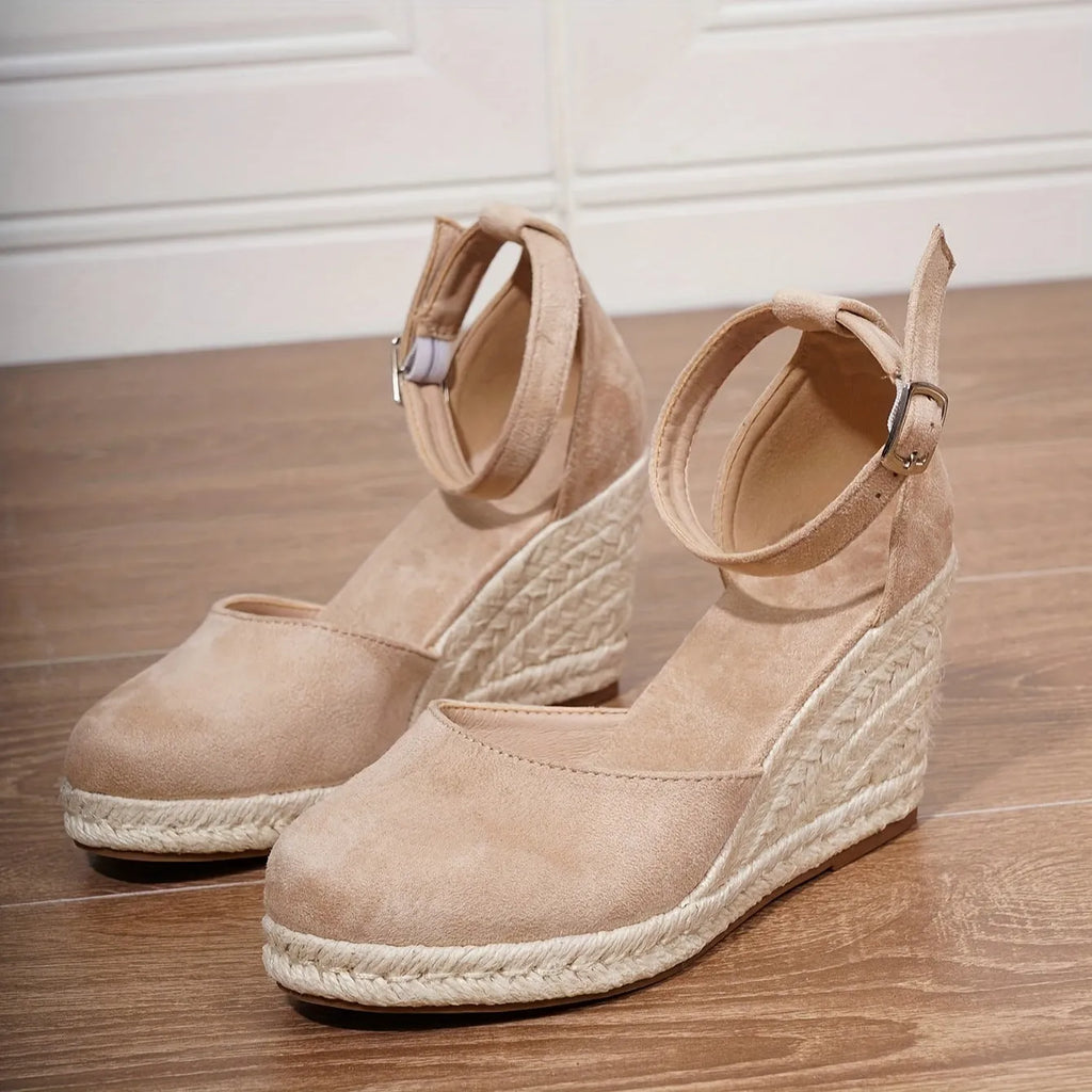 Women's apricot and black canvas wedge sandals with suede upper and buckle strap.