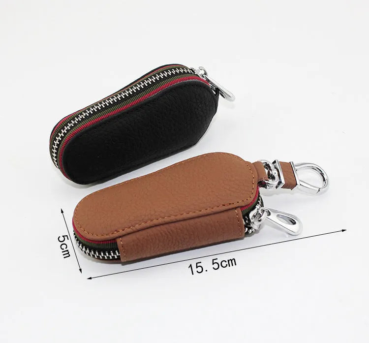 Brown leather car universal key case holding a car key on a white background