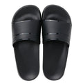 Unisex non-slip bathroom slippers in non-woven fabric with thick sole, available in black or white, sizes S to XXL