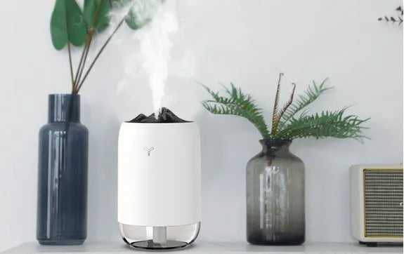 Compact cylindrical mini USB humidifier in turquoise green with a single mist outlet and night light.