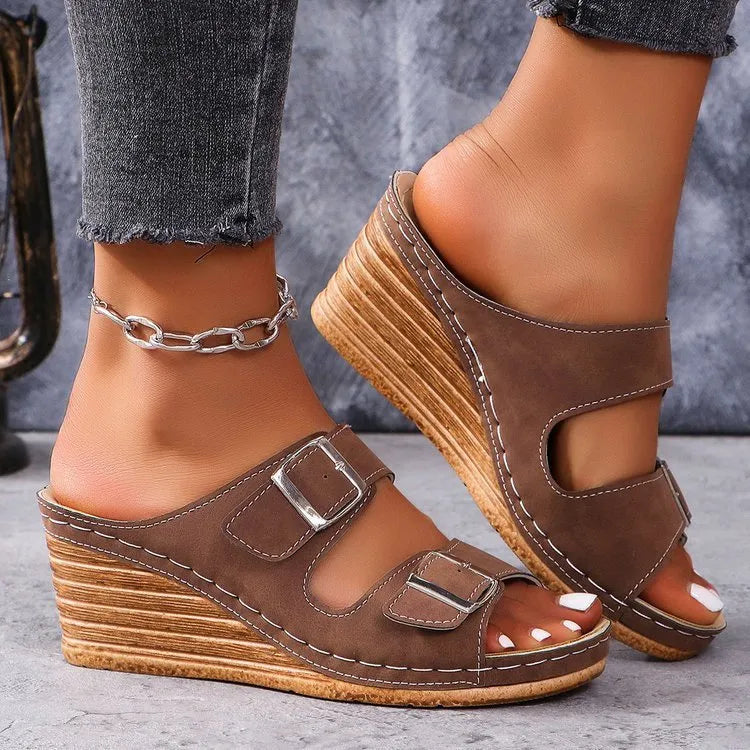 Women's creamy-white beach slippers with a wedge heel and decorative belt buckle on the upper.