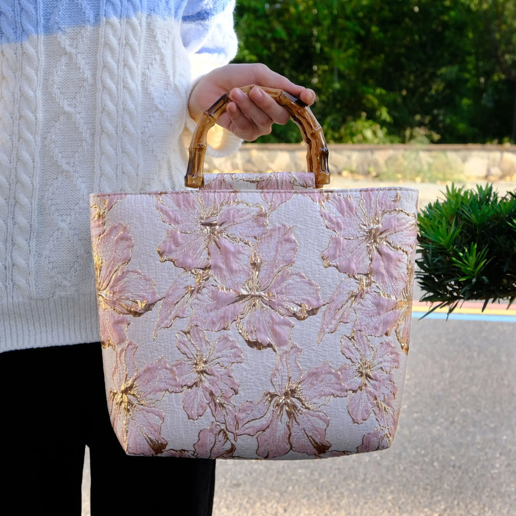 Light blue women's canvas bag with bronzing flower detail and double shoulder straps