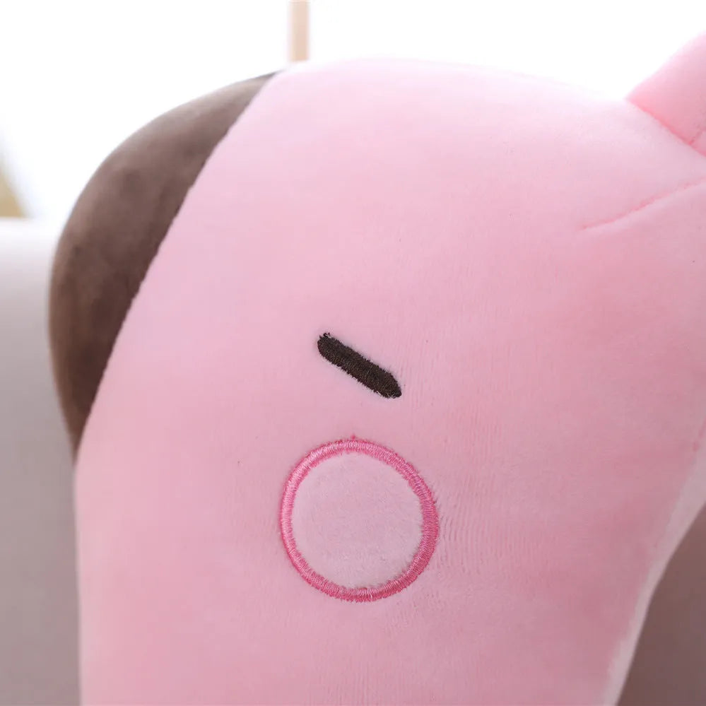 Pink Sika Deer plush doll with short plush fabric, 30cm tall, on a bed