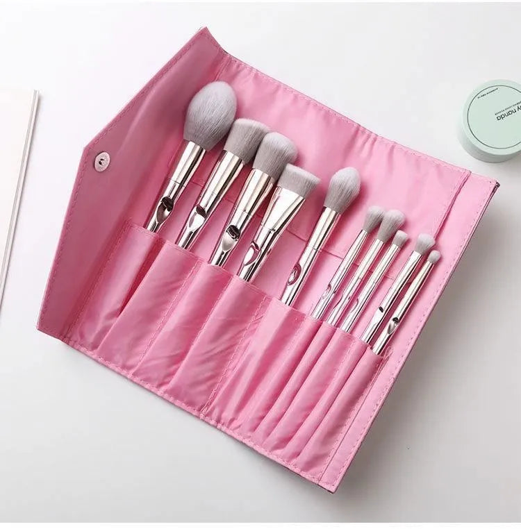 Pink PVC makeup brush set with non-slip grip handle and soft bristles on a light background