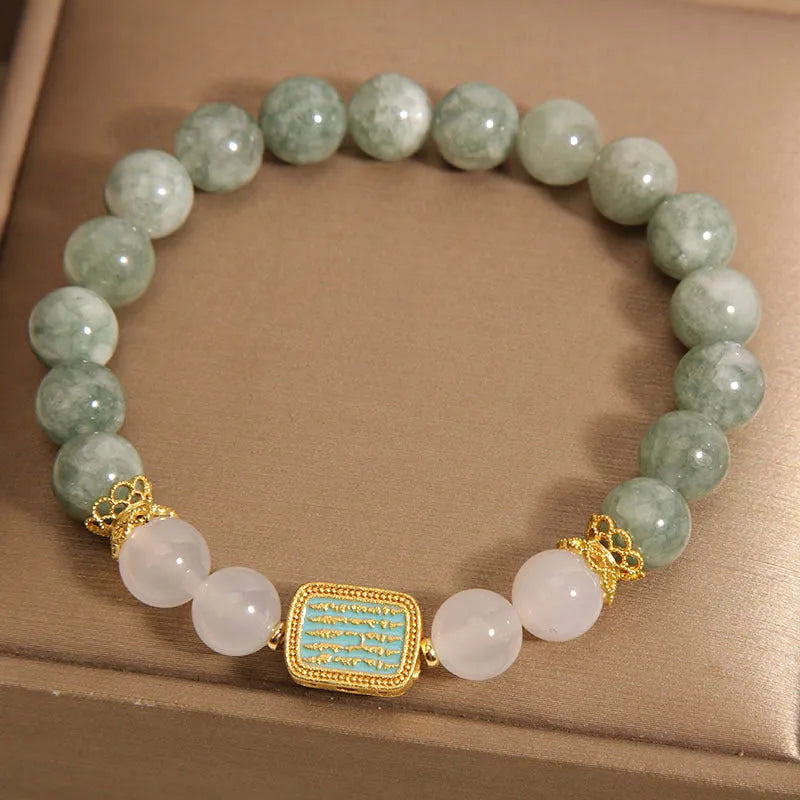 Women's oil green emerald crystal bracelet with five natural gemstones on a wrist.