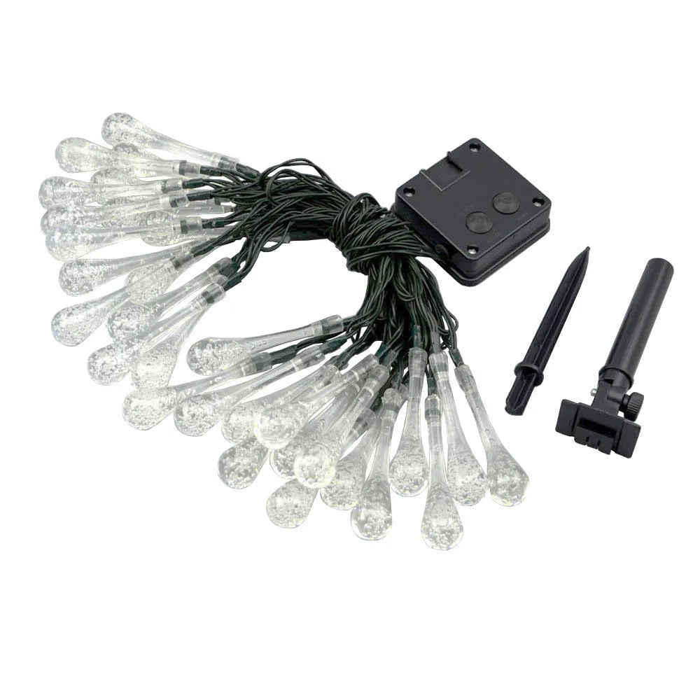 6.5 metre long solar-powered outdoor string lights with water drop shaped pendants on a green lawn.