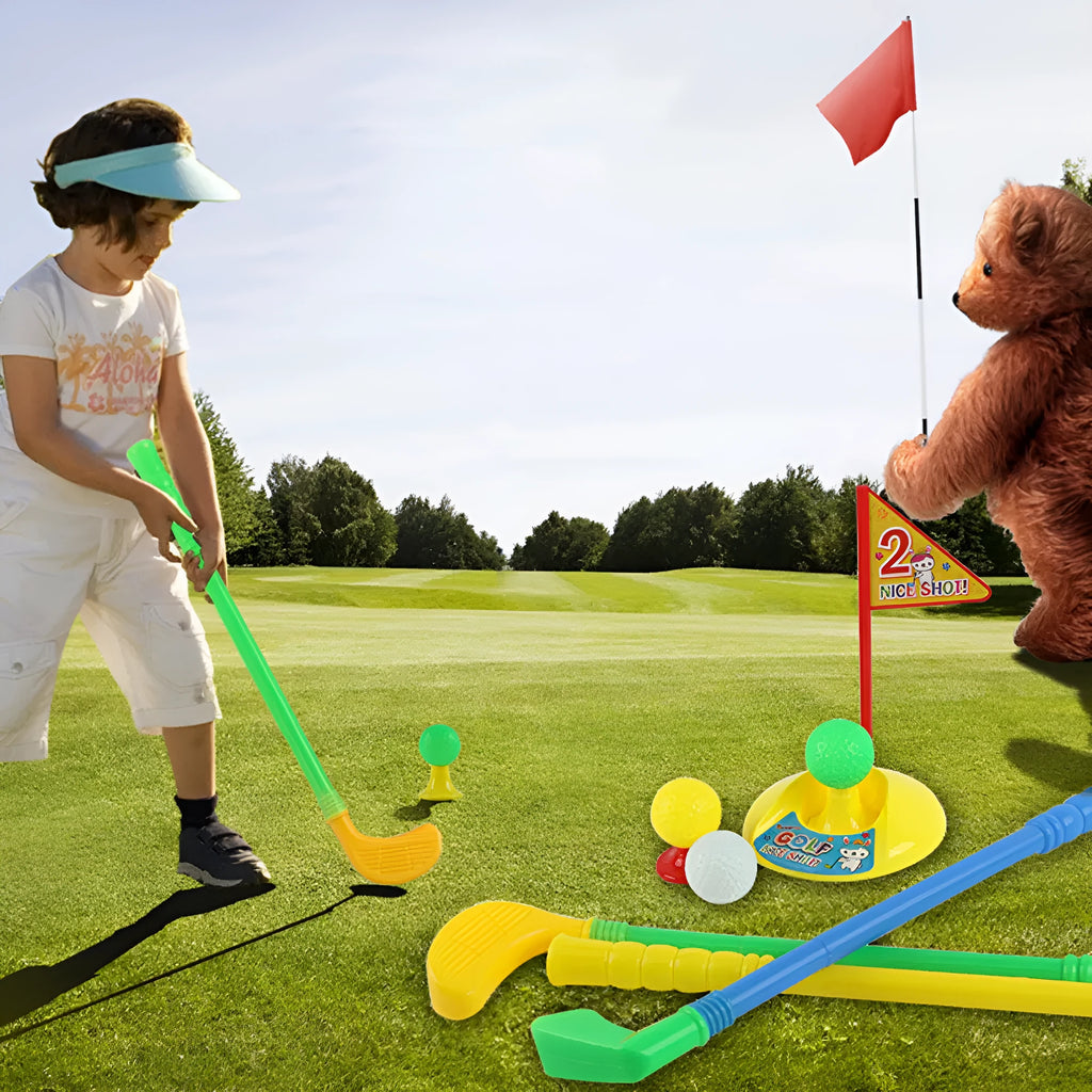 Children's golf set with three multicolour clubs, three balls, a hole, a flag, and two tees on a green background