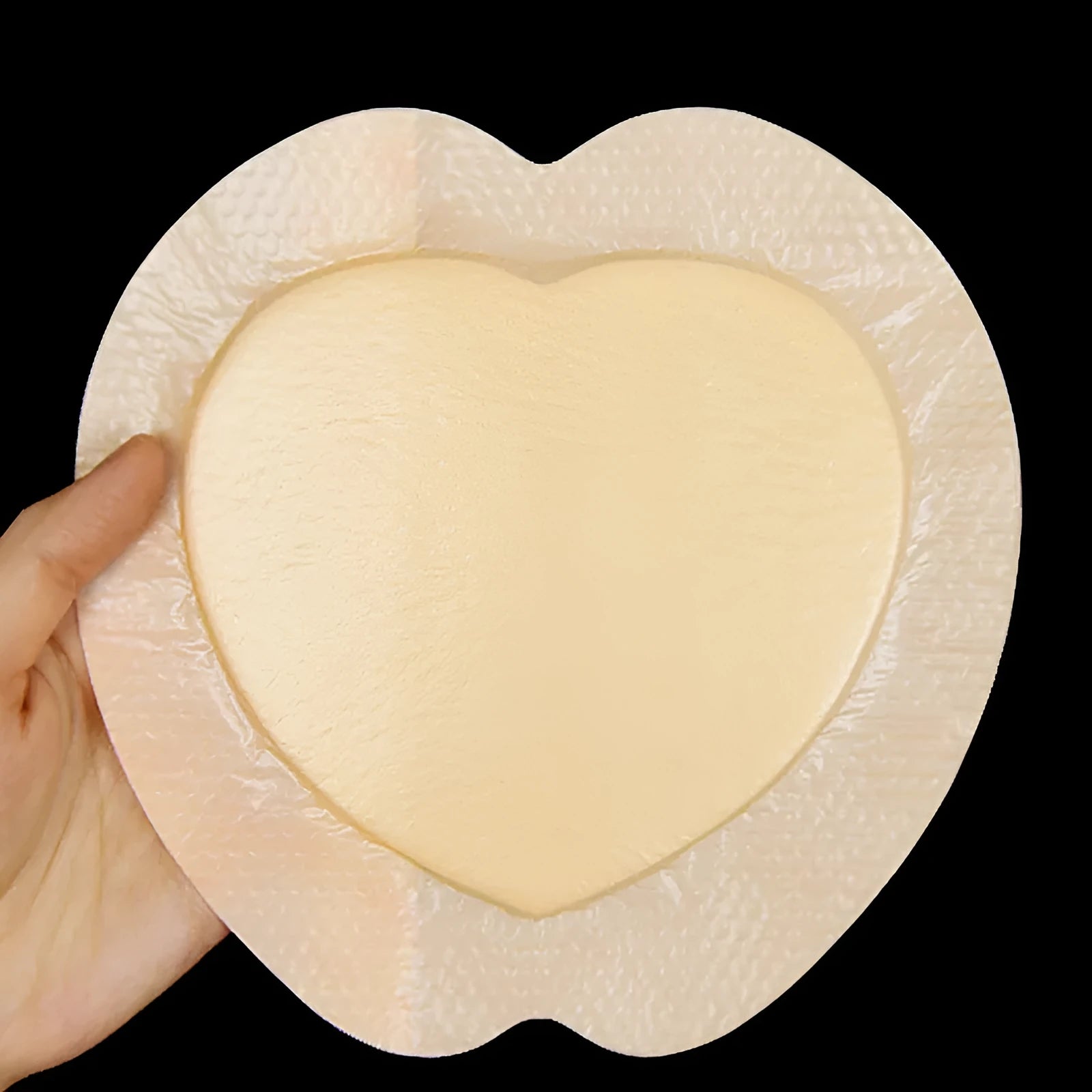 Large skin tone silicone bedsore dressing for pressure sore relief.