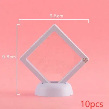 3D floating display case holding a coin suspended between transparent membrane sheets, black frame