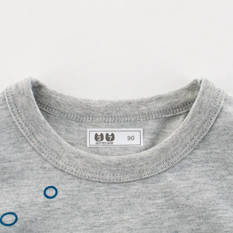 Grey children's cotton T-shirt laid flat, showing size tag with centimetre measurements.