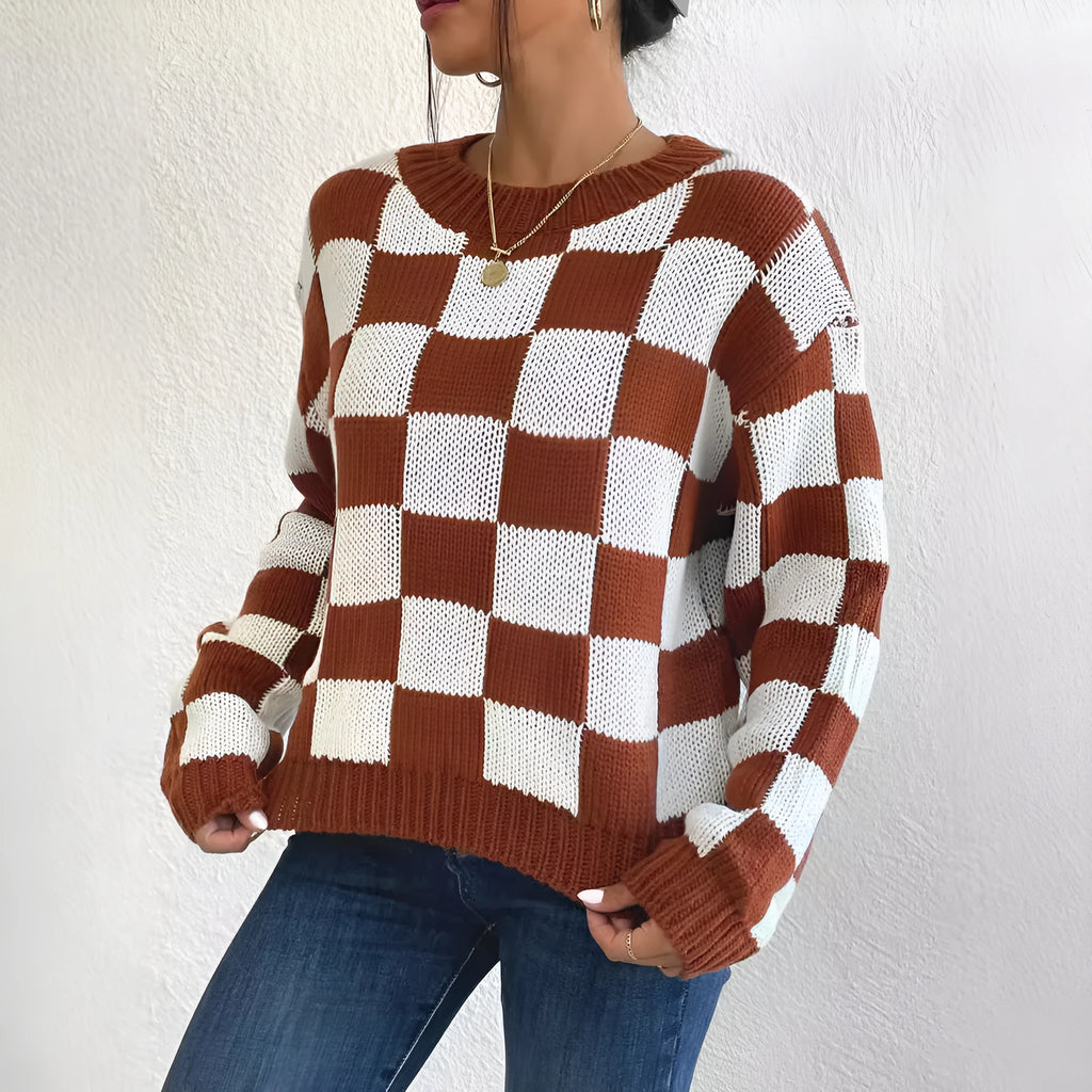 Dark brown plaid loose fit acrylic pullover sweater with long sleeves on a hanger.