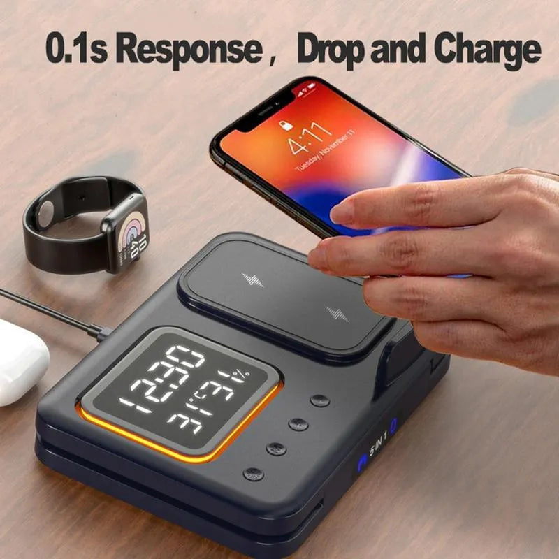 Black and white wireless charging dock station with digital clock display charging a phone, watch and headphones