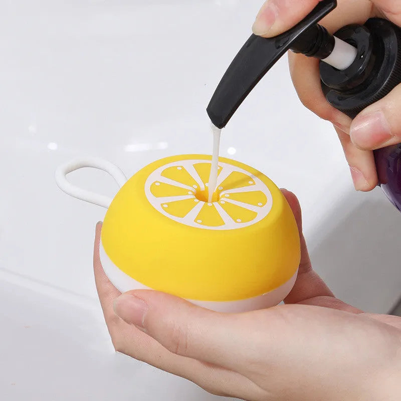 Yellow silicone pet bath brush and grooming comb tool with a 3D massage head on a blue background.