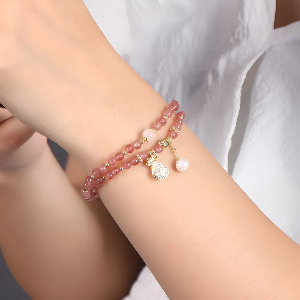 A geometric wallet bracelet for women made from pink strawberry quartz crystal.