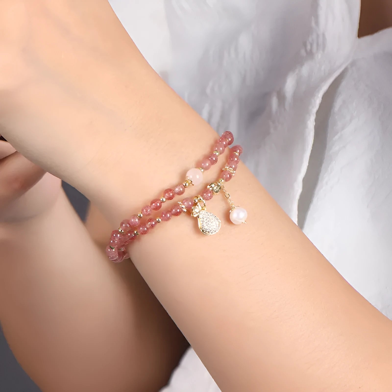 A geometric wallet bracelet for women made from pink strawberry quartz crystal.