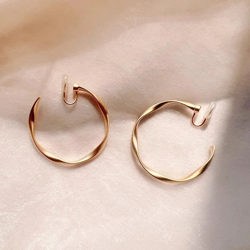 Rotatable circle mosquito coil ear clip in matte gold with rubber pads for women
