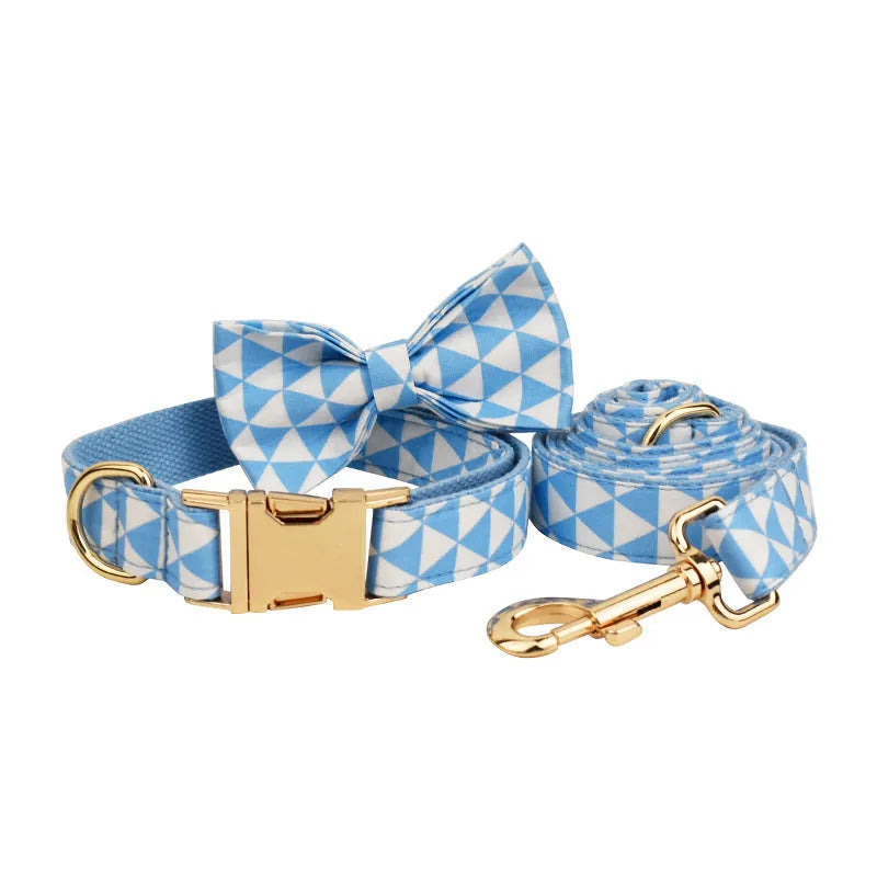 Blue cloth dog vest set with matching collar, leash, and bow tie on a white background