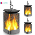Four black solar-powered outdoor torch lights with flickering LED flame effect, placed on a garden patio.