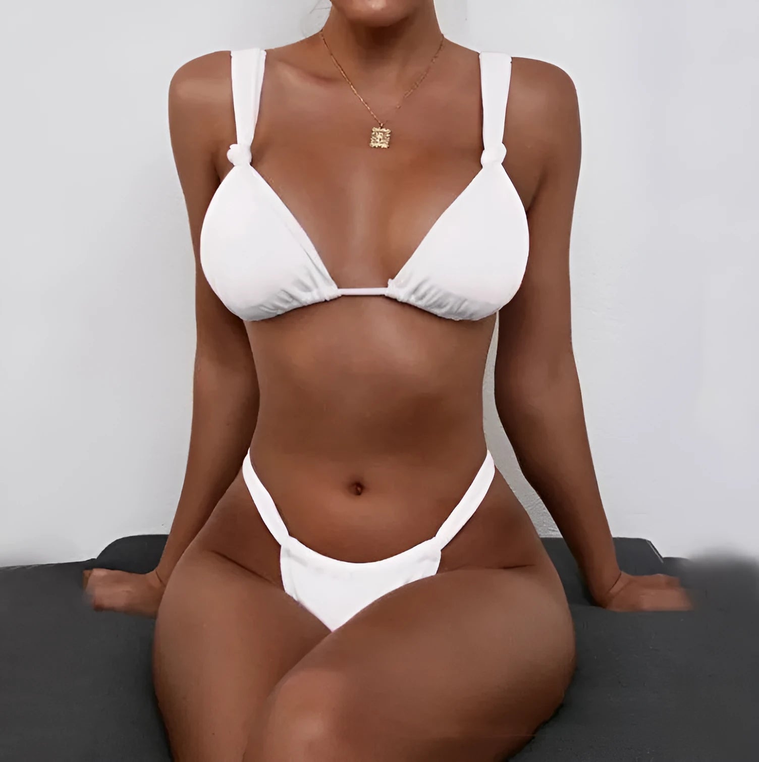 Women's pink bikini with a knotted front and pleated split strap design.