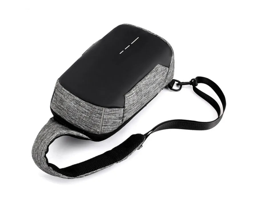 Dark blue Oxford cloth chest bag with a zip and adjustable strap, shown with a phone in its dedicated internal pocket.