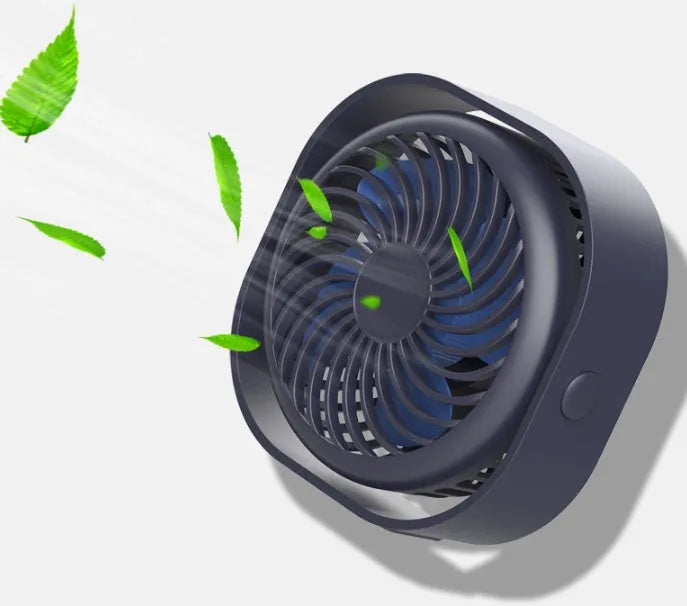Pink USB rechargeable desk fan with rotating head on a wooden desk.