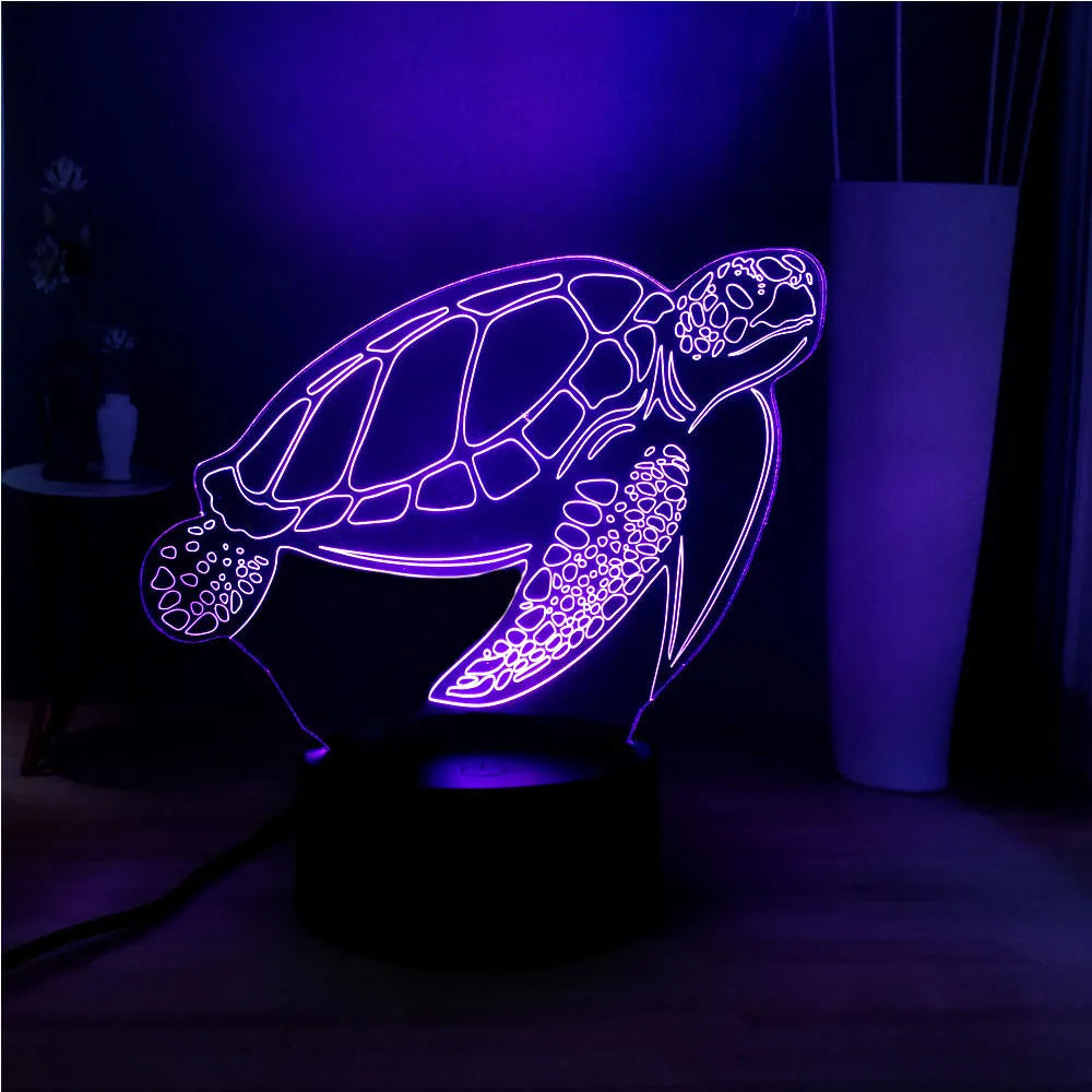 3D acrylic turtle shaped LED night light showing multi-coloured illumination on a shelf.