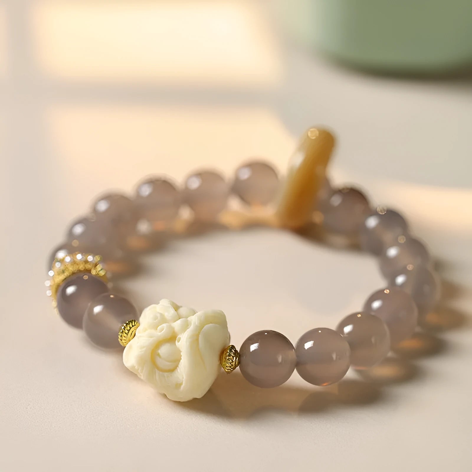 Hand-woven bracelet with 10mm round gray agate and mellite beads, Ivory Xingshi style, unisex design.
