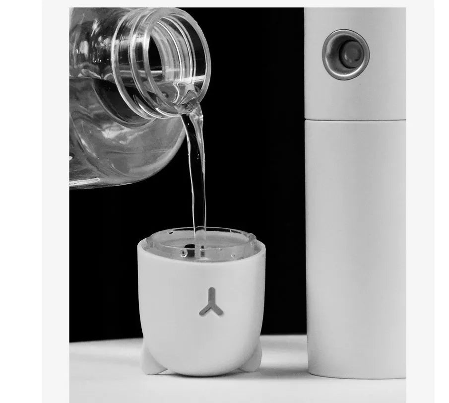 White USB rechargeable handheld spray fan with water tank, flashlight, and power bank function
