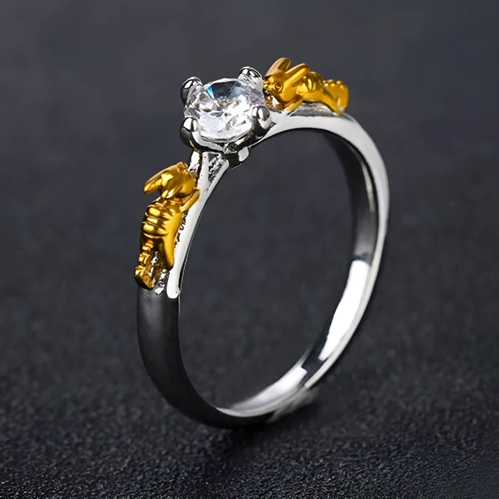 Black gold finished copper ring with a detailed crown motif and crystal settings on a finger.