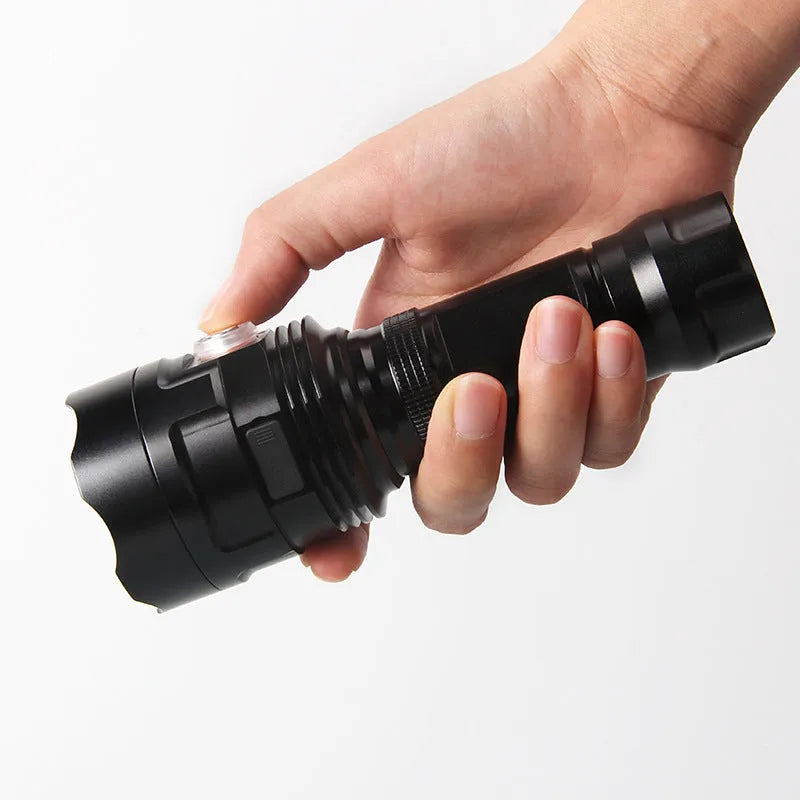 Black aluminium alloy XHP90 LED tactical flashlight showing dimensions and switch.