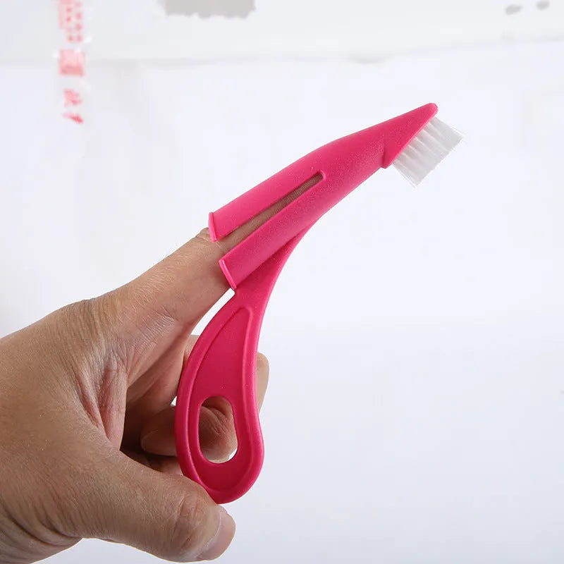 Red and white finger-sleeve toothbrush for dogs and cats with soft silicone bristles.