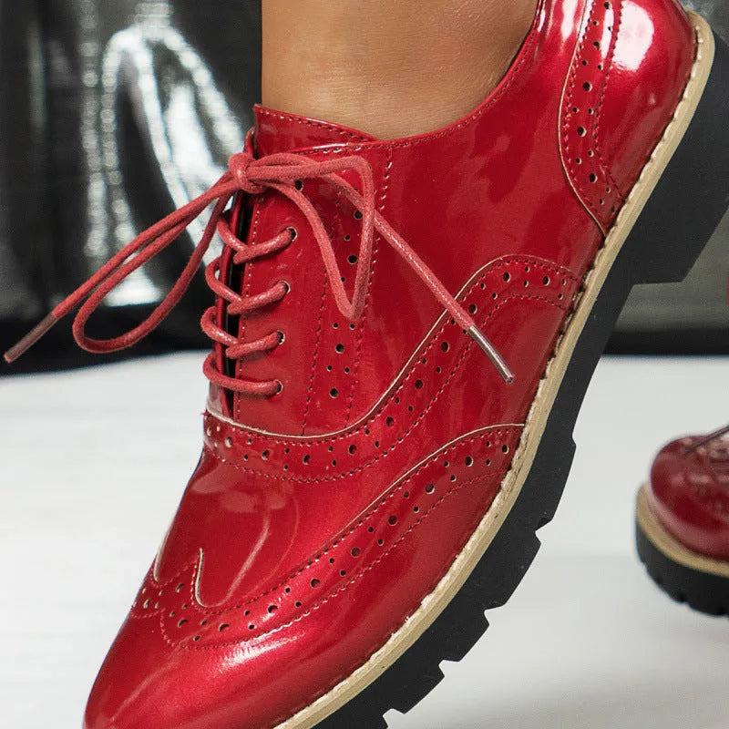 Women's black lace-up Oxford loafers with a wedge heel and sequin detail on the upper.