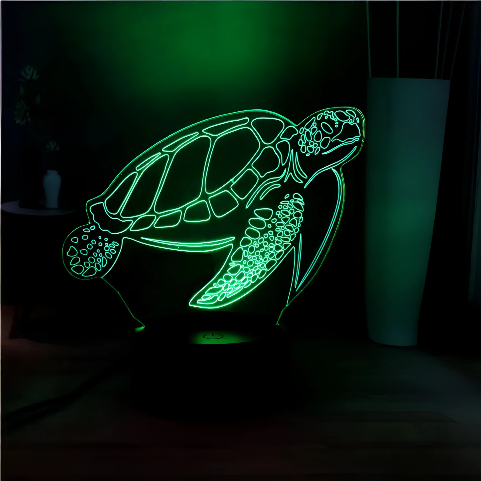 3D acrylic turtle shaped LED night light showing multi-coloured illumination on a shelf.