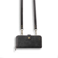 Black leather flip phone case with a detachable wallet backpack, shown open next to a smartphone.