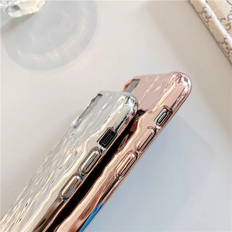 Electroplated rose gold TPU folded back case for iPhone on a table.
