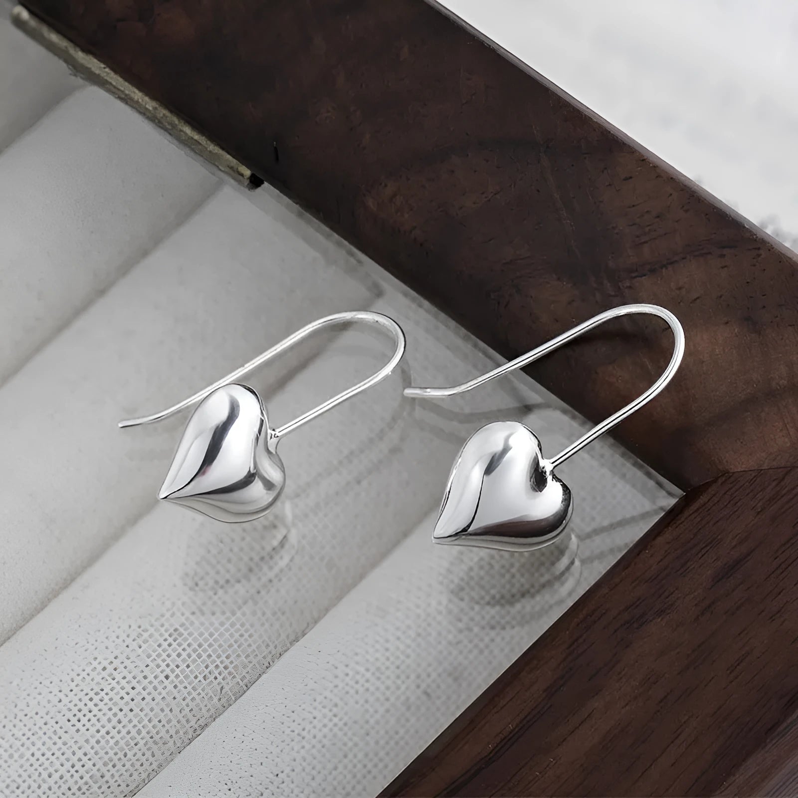 Korean-style glossy silver heart earrings with three-dimensional design and heart-shaped hooks