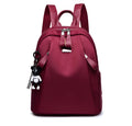 Medium wine red Oxford cloth rucksack showing internal phone and ID compartments